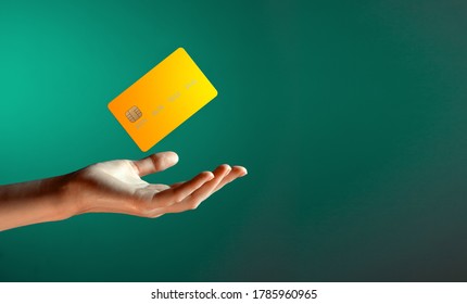 Close up female hand holds levitating template mockup Bank credit card with online service isolated on green background - Shutterstock ID 1785960965