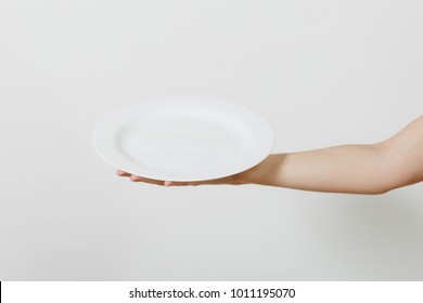 Close up of female hand horizontal holding white round plate isolated on white background. Kitchen utensils concept. Copy space for advertisement