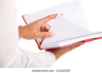 Close up of female hand making notes in calendar