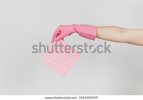 Close up of female hand in pink gloves\
horizontal holds pink absorbent napkin for cleaning and washing\
dishes isolated on white background. Cleaning supplies concept.\
Copy space for\
advertisement.