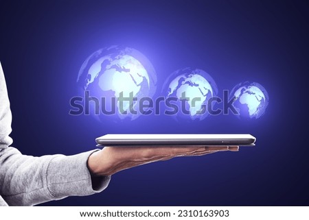 Close up of female hand using cellphone with glowing digital globe hologram on dark background. Digital world, global hacking protection and hud concept