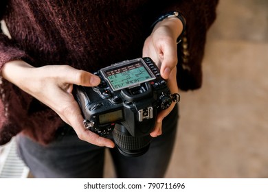 Close up female hands adjust settings on camera - Powered by Shutterstock