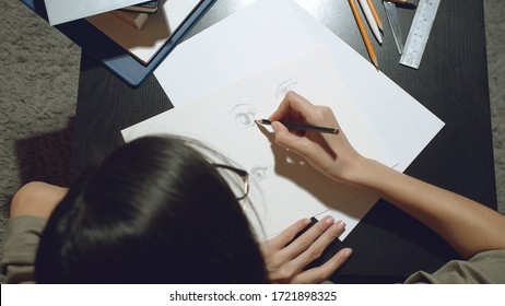 Close up of female hands of an artist or Illustrator drawing pencil sketches on paper. - Powered by Shutterstock