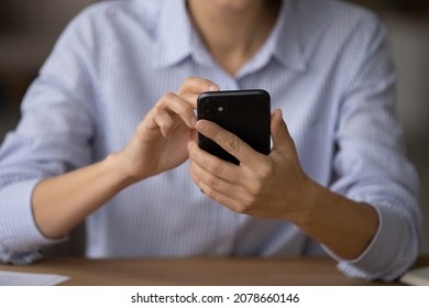 Close up female hands holds smartphone use new mobile app. E-commerce client buying on internet, reading social media news, make purchase remotely via virtual services. Modern tech usage, 5g concept - Powered by Shutterstock