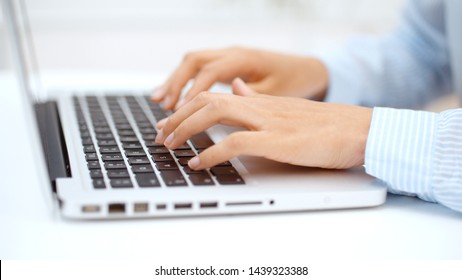 Close up of female hands pressing keys of laptop keypad. 