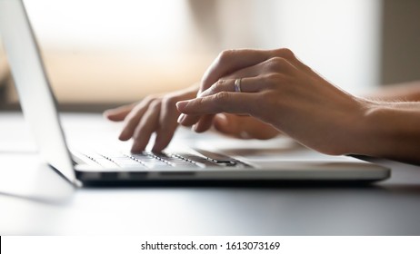 Close Up Of Female Hands Typing On Modern Laptop Keyboard Making Notes Writing On Device, Young Caucasian Woman Text Message Using Computer Gadget At Home, New Technology Concept