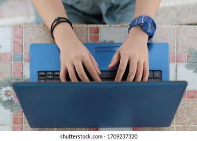 Close up of female hands while typing on laptop