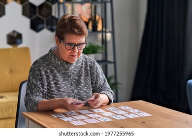 Close up of female holding cards and playing solitaire