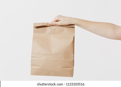 Close up female holds in hand brown clear empty blank craft paper bag for takeaway isolated on white background. Packaging template mock up. Delivery service concept. Copy space. Advertising area - Shutterstock ID 1123103516