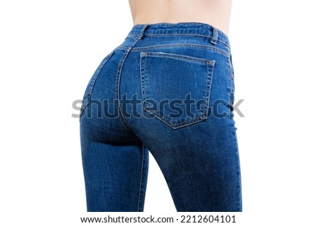 Close up of female jeans with perfect fit. Denim pants type. Woman hips isolated on white background. Copy space. Selective focus. Back hips view in trousers. Fashion clothes
