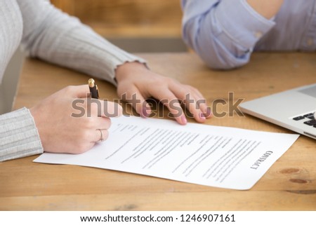 Close up of female job candidate sign contract after successful interview, woman put signature on document, finalize recruiting process, work applicant fill in paper business deal. Employment concept