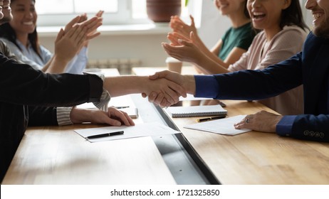 Close up female leader and businessman shaking hand congratulation on successful contract. Manager making business deal on clap hands colleague at meeitng. Confirm successful handshake gesture.