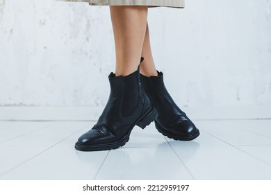 Close Up Of Female Legs In Black Leather Boots. New Autumn Collection Of Women's Leather Shoes 2022