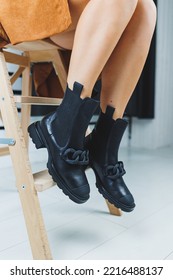 Close Up Of Female Legs In Black Leather Boots. Women's Autumn Shoes.