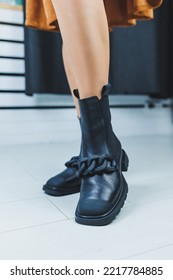 Close Up Of Female Legs In Black Leather Boots. Women's Autumn Shoes.