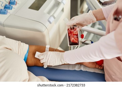 Close Up Of Female Nurse Helping Donors And Setting Up Machines At Blood Donation Center