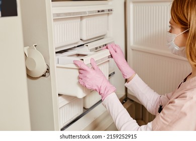 Close Up Of Female Nurse Opening Storage Fridge At Blood Donation Center