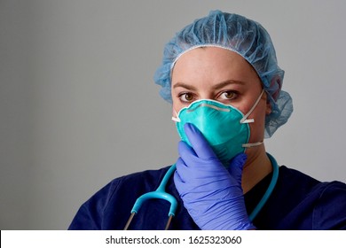 Close up of a female nurse putting on a respirator N95 mask to protect from airborne respiratory diseases such as the flu, coronavirus, ebola, TB, etc