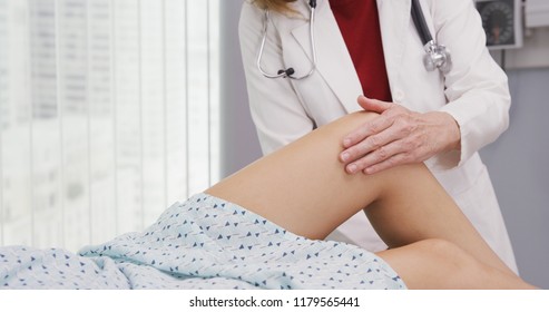 Close Up Of Female Patient With Knee Injury And Medical Doctor Rehabilitating It