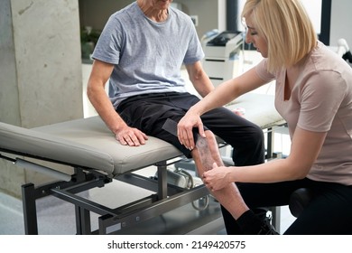 Close up of female physical therapist working with her patient  - Powered by Shutterstock