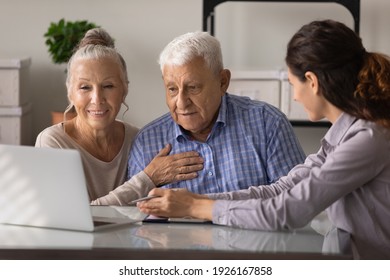 Close Up Female Realtor Manager Real Estate Agent Consulting Mature Couple About Mortgage Or Rent, Looking At Laptop Screen, Senior Family Wife And Husband Listening To Financial Advisor Broker