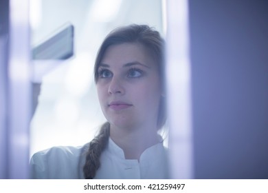 Close Up Of Female Scientist Examining Microscopy Slide