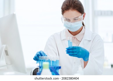 Close Up .female Scientist Looking At Test Tube .