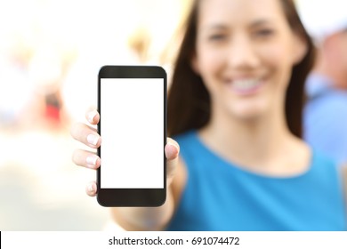 Close up of a female showing a blank vertical phone screen on the street