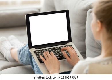 Close up of female sit on cozy sofa writing email on laptop, girl freelancer working at computer from home, focused student studying un bed, woman texting with friend or writing message to colleague - Shutterstock ID 1230899569