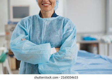 Close Up Of Female Surgeon Standing In Operating Room With Crossing Hands