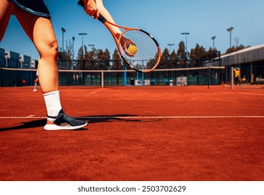 Close up of female tennis player preparing to serve. - Powered by Shutterstock