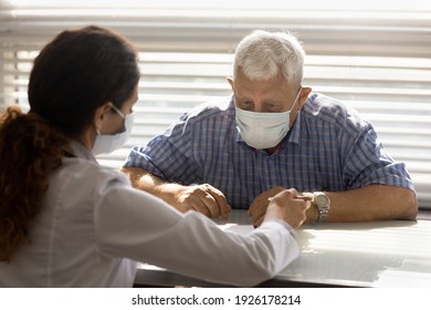 Close Up Female Therapist Consulting Mature Man Patient Wearing Medical Face Mask About Health Insurance Agreement, Contract Terms, Discussing Checkup Results, Prescriptions, Healthcare Concept