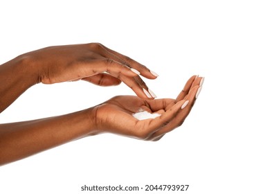 Close Up Of Female Woman Applying Organic Cream On Hand. Detail Of Hands Of Ethnic Woman With Hand Lotion Isolated Against White Background. Skin Care And Beauty Manicure Concept.