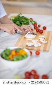 Close Up Of Females Hands Cutting Veggies