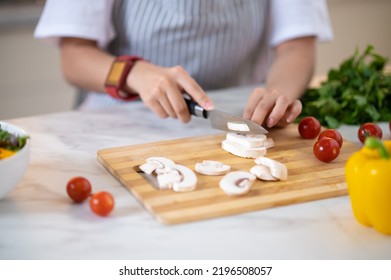 Close Up Of Females Hands Cutting Veggies