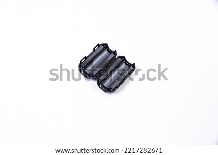 Close up of a ferrite bead inductor. An electrical element that suppresses high-frequency electronic noise in electronic circuits. on isolated white