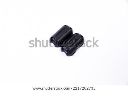 Close up of a ferrite bead inductor. An electrical element that suppresses high-frequency electronic noise in electronic circuits. on isolated white