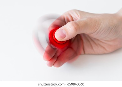 close up of fidget spinner rotating in female hand over white background - Powered by Shutterstock