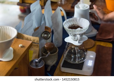 Close up of filter coffee maker, kettle with thermometer and digital scale on wooden table.Barista brewing coffee, method pour over, drip coffee