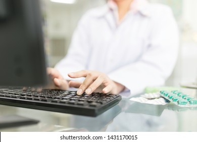 close up finger, healthcare worker typing information with computer in hospital, she holding hand on keyboard on counter - Powered by Shutterstock