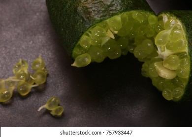 Close Up Of Finger Limes Or Caviar Limes On Black Stone Background. Fruits For Decorate Dish.