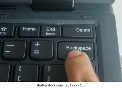 Close up of finger pressing Backspace button on laptop keyboard, computer input, editing and modern technology concept