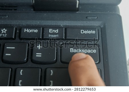 Close up of finger pressing Backspace button on laptop keyboard, computer input, editing and modern technology concept