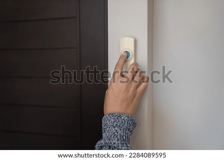 close up finger pressing doorbell