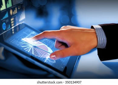 Close up of finger touching blue toned screen on tablet pc - Shutterstock ID 350134907