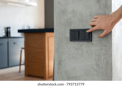 Close Up Of Finger Is Turning On Or Off On Light Switch.