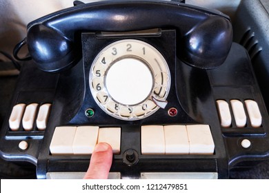 Close Up Finger Using Of The Retro Rotary Telephone. Old Black Telephon With Rotary Dial. Vintage Phone With Switchboard Operator