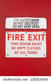 Close Up Of Fire Exit Warning Sign On A Red Wall In Sydney Australia