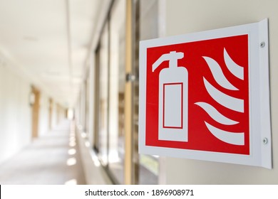 Close up fire extinguisher sign in the building corridor. Selective focus image. Emergency sign.