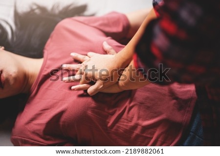 Close up First aids emergency CPR on heart attack woman laying unconscious in home, One part of the process resuscitation - healthcare and insurance concept.